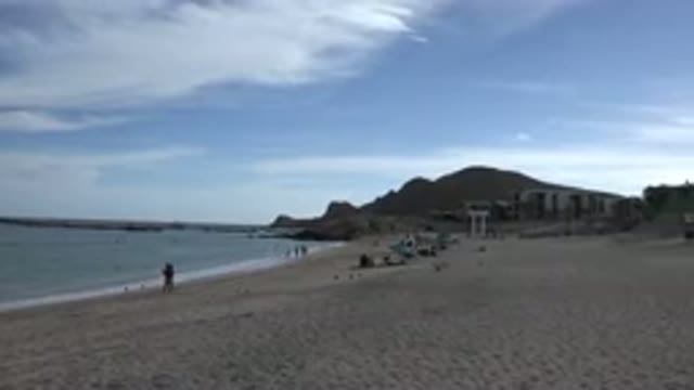 CABO SAN LUCAS MEXICO-2017: Sleeping On The Beach With Waves And A Blue Sky In