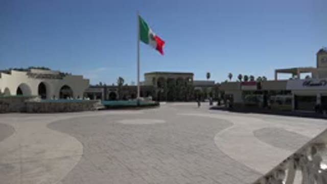 LOS CABOS MEXICO-2017: Strolling By The Flag On A Hot Day