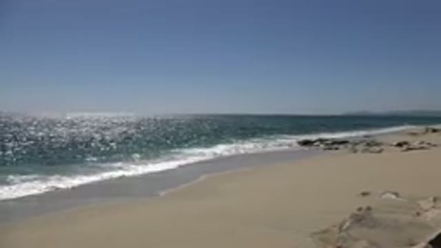 LOS CABOS MEXICO-2017: The Sea Lapping on the Shore of a Sandy Beach with Dune