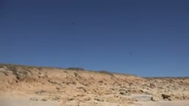 LOS CABOS MEXICO-2017: Seagulls Flying Over The Arid Mountain Over The Blue And