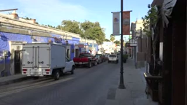 LOS CABOS MEXICO-2017: White Car Driving Through A Quiet Residential Street Full