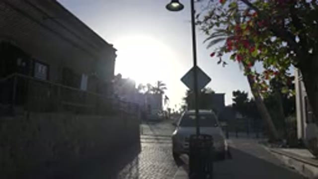 LOS CABOS MEXICO-2017: Car Parked In Front Of Road Sign With The Sun Shining In