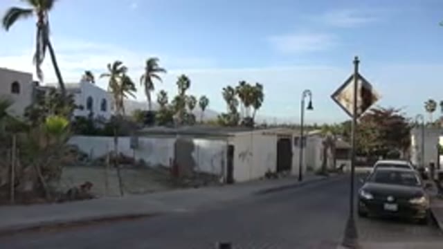 LOS CABOS MEXICO-2017: Street With Lots Of Houses Cars And People Walking Near