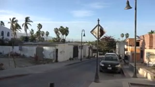 LOS CABOS MEXICO-2017: Cars Are Parallel Parked On A Cobblestone Street Flanked