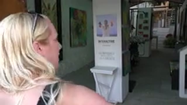 LOS CABOS MEXICO-2017: Lady Moving Stationary Painting Along Walls Stairs In