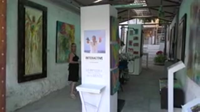 LOS CABOS MEXICO-2017: Art Gallery Exhibit With Different Paintings And A Woman Observing