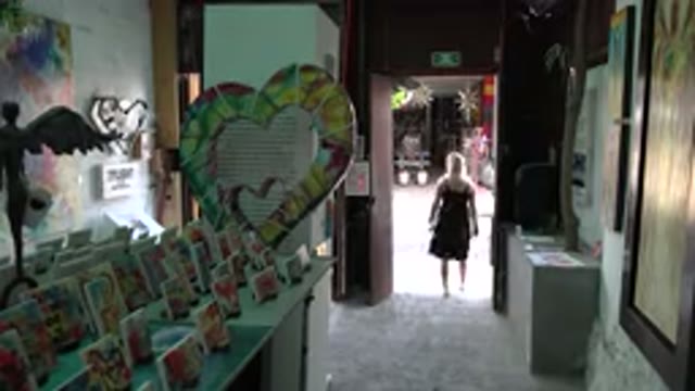LOS CABOS MEXICO-2017: A Woman Emerging From A Shop And Turning To Her Left