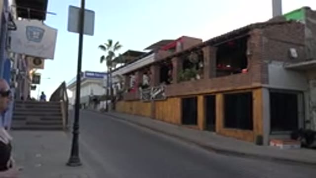 LOS CABOS MEXICO-2017: A Person With Sunglasses Is Walking Up To The Street And