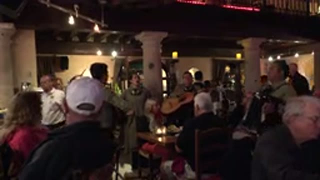 LOS CABOS MEXICO-2017: Singing Mexicans and Caucasians in Crowded Restaurant with Food and Drinks
