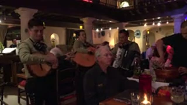 LOS CABOS MEXICO-2017: Man Playing Musical Instrument With Others Enjoying