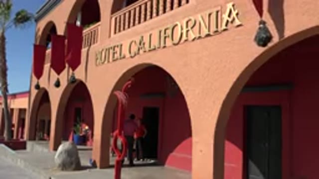 LOS CABOS MEXICO-2017: Hotel Painted In Crimson Color With Flags Adorning The Entrance