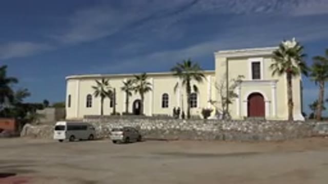 LOS CABOS MEXICO-2017: People Roaming In Front Of Large Building With Red Door