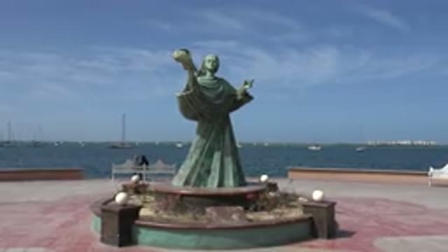 LOS CABOS MEXICO-2017: Still Shot Of Green Copper Statue Of Woman Holding An Object