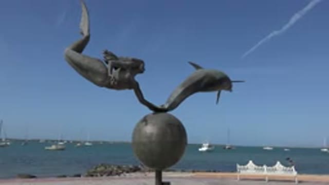 LOS CABOS MEXICO-2017: A View Of A Statue With Beach And Water Behind