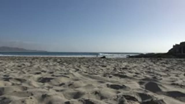 LOS CABOS MEXICO-2017: People On The Beach With Medium Waves And White Sand