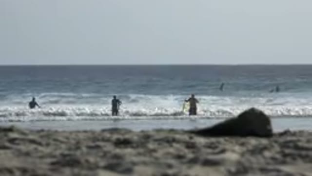 LOS CABOS MEXICO-2017: Someone on the Beach with a Wave Coming In