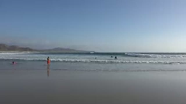 LOS CABOS MEXICO-2017: People At The Beach And In The Ocean With Waves Rolling