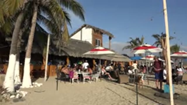 LOS CABOS MEXICO-2017: Many People Under The Beach Umbrella On The Beach Sand On