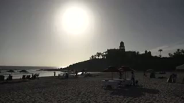 LOS CABOS MEXICO-2017: Silhouette Beach Scene With Umbrellas And Low Sun