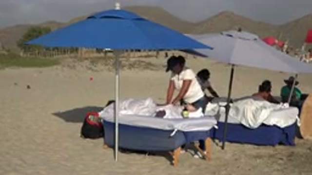 LOS CABOS MEXICO-2017: A View Of Outdoor Massage Therapy Under Blue Umbrella On Sand