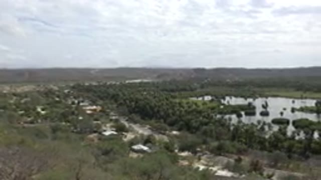LOS CABOS MEXICO-2017: Sweeping Shot Of Verdant Countryside Bushes Shrubs And Lake
