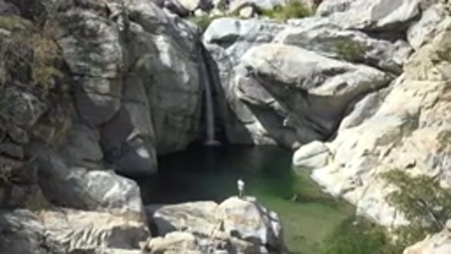 LOS CABOS MEXICO-2017: The Image Of A Waterfall Surrounded By Rocks And Some