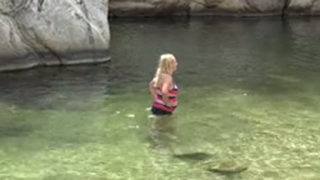 LOS CABOS MEXICO-2017: Middle Aged Woman Wading in Natural Rock Pool with Hands
