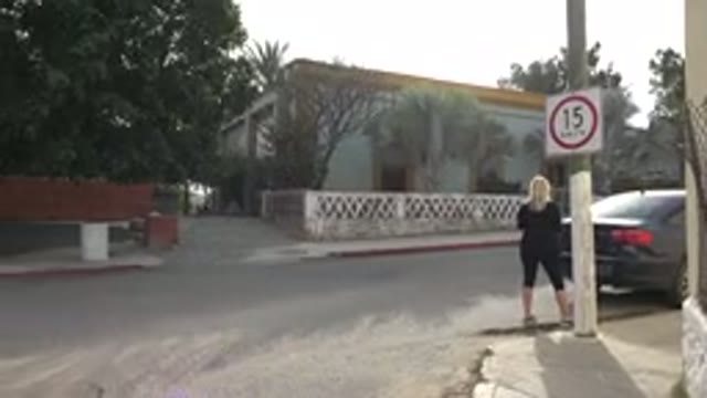 LOS CABOS MEXICO-2017: The Corner Of A Neighborhood With Houses And Cars And A Blonde Woman