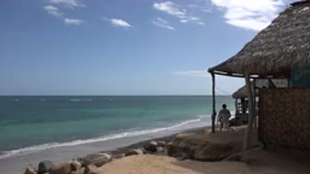 CABO PULMO MEXICO-2017: Man Relaxes In Beach Bungalow As Waves Gently Wash Into