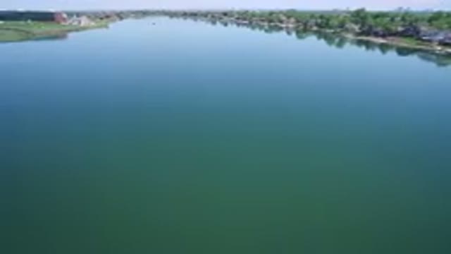 WESTMINSTER COLORADO-2017: Open Lake With Calm Water Surrounded By Houses And Trees