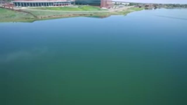 WESTMINSTER COLORADO-2017: Large Blue Green Lake Next To Industrial Park And