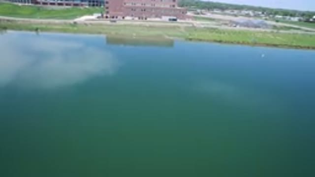 WESTMINSTER COLORADO-2017: Cars Passing By A Waterfront Building On A Sunny Day