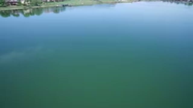 WESTMINSTER COLORADO-2017: Blue And Green Lake With Green Grass On The Shore