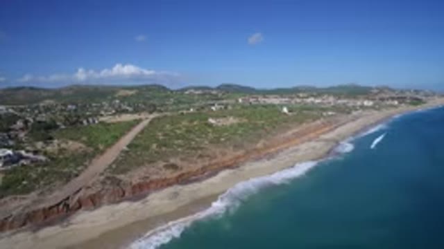 PLAYITA BCS MEXICO-2017: Blue Ocean Waves Moving Toward Sandy Beach Near Small
