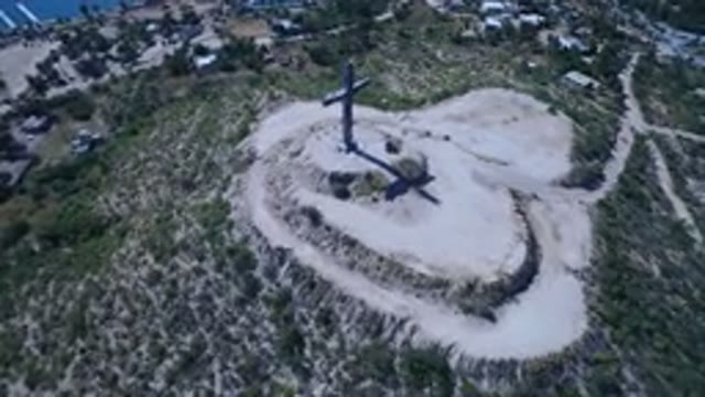 SAN JOSE DEL CABO MEXICO-2017: Aerial Scene Of A Big Crucifixion On A Rocky And Grassy Hillside