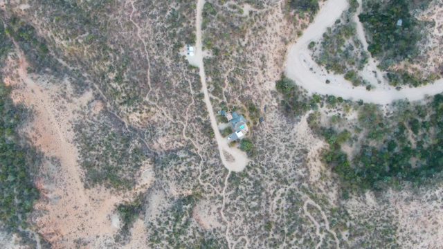CABO PULMO BCS MEXICO-2023: Desert Landscape with Small Structure and Winding Road