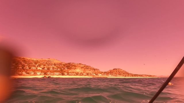 SAN JOSE DEL CABO BCS MEXICO-2023: Fishing From a Boat Near Coastal Hills at Dusk