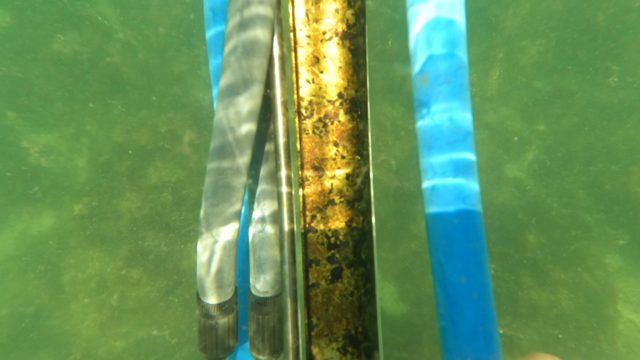 SAN JOSE DEL CABO BCS MEXICO-2023: Hand Holding Rusted Metal Object Underwater