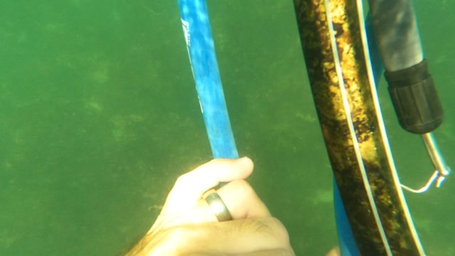 SAN JOSE DEL CABO BCS MEXICO-2023: Hand Adjusting Diving Strap Near Rusted Underwater Pipe