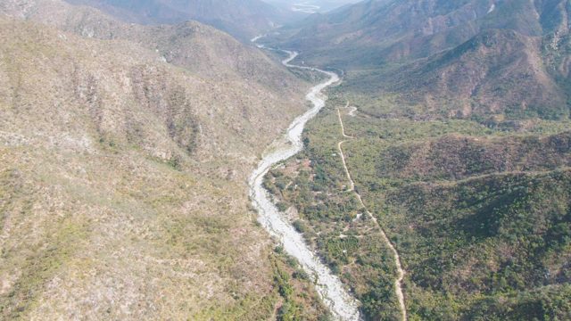 SAN DIONISIO BCS-2023: Winding River Flowing Through Mountain Valley