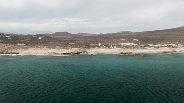 SHIPWRECKS EAST CAPE BCS-2023: Waves Crashing on Sandy and Rocky Coastline