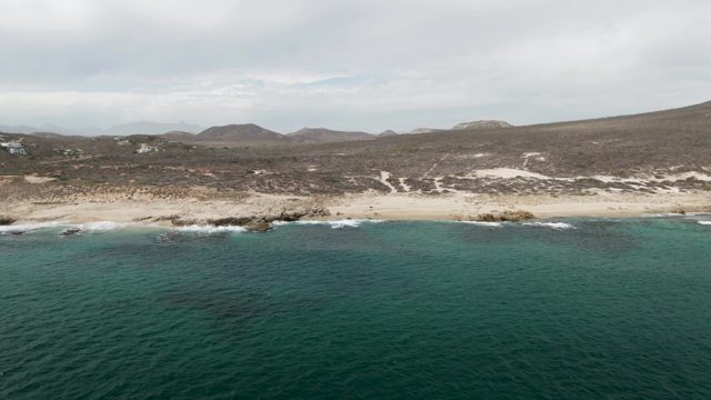 SHIPWRECKS EAST CAPE BCS-2023: Sandy Beach With Turquoise Ocean And Rocky Shore