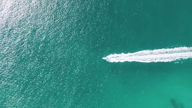 BUZZARDS BEACH EAST CAPE BCS-2023: Speedboat Cutting Through Turquoise Ocean Waters