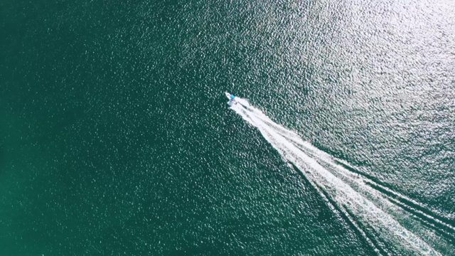 BUZZARDS BEACH EAST CAPE BCS-2023: Speedboat Creating White Wake on Ocean Surface
