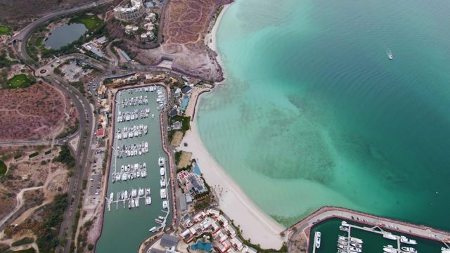 LA PAZ BCS-2023: Coastal Marina and Sandy Beach with Moving Boats