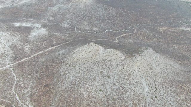 PUNTA GORDA BEACH BCS-2023: Hilly Landscape Under Snowfall with Winding Road