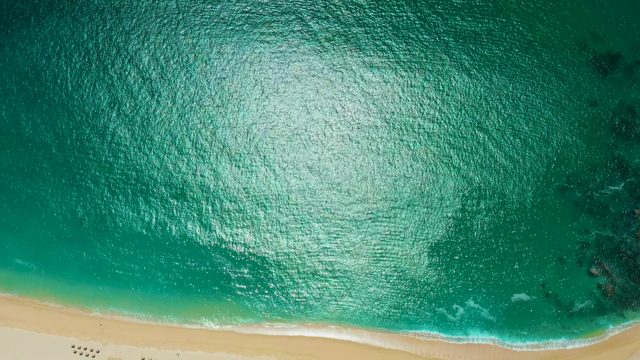 MARQUIS LOS CABOS MEXICO-2021: Gentle Ocean Waves Lapping a Sandy Beach
