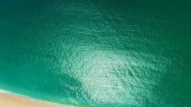 MARQUIS LOS CABOS MEXICO-2021: Gentle Ocean Waves Rolling Toward Sandy Beach