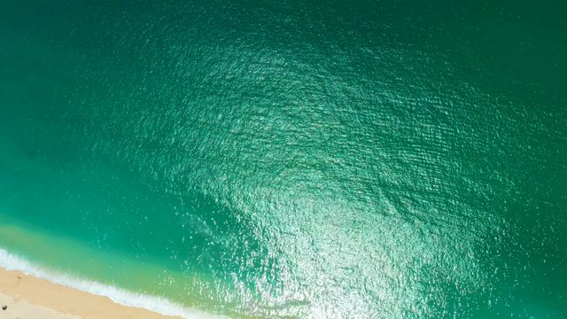 MARQUIS LOS CABOS MEXICO-2021: Gentle Ocean Waves Rolling Onto Sandy Beach