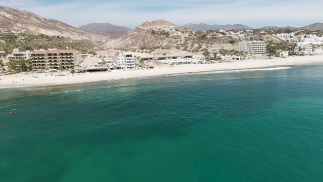 PUNTA GORDA BEACH BCS-2023: Beach Shoreline with Turquoise Water and Coastal Buildings